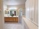 A bright bathroom offers a double sink vanity, glass enclosed shower, and ample storage at 3555 Chapel Hill Blvd, Clermont, FL 34711