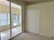 A bedroom features a sliding glass door and double closet with sliding mirrored doors at 3555 Chapel Hill Blvd, Clermont, FL 34711