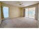 A spacious carpeted bedroom includes a sliding glass door and large window at 3555 Chapel Hill Blvd, Clermont, FL 34711