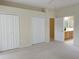 Bright bedroom with carpet, double closets, and an ensuite bathroom at 3555 Chapel Hill Blvd, Clermont, FL 34711
