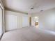 Spacious bedroom with plush carpet, ceiling fan, and double closets, adjacent to the bathroom at 3555 Chapel Hill Blvd, Clermont, FL 34711