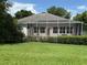 Back view of home featuring screened in lanai and lush green backyard at 3555 Chapel Hill Blvd, Clermont, FL 34711