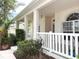 Inviting front porch with white pillars and decorative railing, creating a warm and welcoming entrance to the home at 3555 Chapel Hill Blvd, Clermont, FL 34711