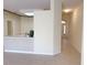A hallway features tan walls, neutral tile floors, and an arched doorway to the home's front entryway at 3555 Chapel Hill Blvd, Clermont, FL 34711