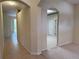 Inviting hallway featuring tiled floors, arched doorways, and neutral paint tones at 3555 Chapel Hill Blvd, Clermont, FL 34711