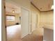 Hallway area featuring wallpaper, tile flooring, and multiple doorways at 3555 Chapel Hill Blvd, Clermont, FL 34711
