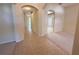 Bright hallway featuring neutral walls, tile flooring, and arched doorways leading to additional rooms in the house at 3555 Chapel Hill Blvd, Clermont, FL 34711