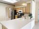 Bright kitchen features a center island, stainless appliances, and tile flooring for a functional and attractive culinary space at 3555 Chapel Hill Blvd, Clermont, FL 34711