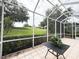 Screened-in lanai with views of a green lawn, ideal for enjoying the outdoors while staying protected from the elements at 3555 Chapel Hill Blvd, Clermont, FL 34711