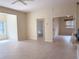 The open living space includes neutral tile flooring, tan walls, and access to other rooms in the home at 3555 Chapel Hill Blvd, Clermont, FL 34711