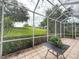 Relaxing screened-in patio with table and view of the greenery outside at 3555 Chapel Hill Blvd, Clermont, FL 34711