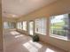 Bright sunroom boasting many windows with views of the green grounds outside at 3555 Chapel Hill Blvd, Clermont, FL 34711