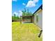 Open patio extends from home into a spacious, grassy backyard enclosed with wooden fencing at 4002 Sw 158Th Street Rd, Ocala, FL 34473