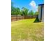 Spacious backyard featuring a tall wooden fence and green grass at 4002 Sw 158Th Street Rd, Ocala, FL 34473