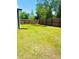 Large backyard featuring privacy fence, green lawn, and ample space for outdoor enjoyment at 4002 Sw 158Th Street Rd, Ocala, FL 34473