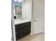 Bathroom featuring a tile shower, vanity, and a door at 4002 Sw 158Th Street Rd, Ocala, FL 34473