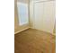 Cozy bedroom with carpet flooring, a window with blinds, and a double door closet at 4002 Sw 158Th Street Rd, Ocala, FL 34473