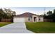Charming one-story home with a spacious front yard, long driveway, and a two-car garage at 4002 Sw 158Th Street Rd, Ocala, FL 34473
