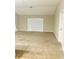 Bright living room with sliding doors, carpet flooring, and neutral color scheme at 4002 Sw 158Th Street Rd, Ocala, FL 34473