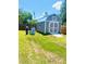 Backyard shed offering extra storage, painted a stylish gray, with green grass and sky overhead at 4002 Sw 158Th Street Rd, Ocala, FL 34473