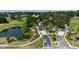 Aerial view of The Legends Golf & Country Club entrance and surrounding community, including a pond at 4239 Fawn Meadows Cir, Clermont, FL 34711