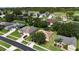 An aerial view of homes in a beautiful, green neighborhood with a well-maintained streetscape at 4239 Fawn Meadows Cir, Clermont, FL 34711