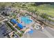 Bird's eye view featuring a sparkling community pool, spa, and beautifully maintained landscaping and golf course at 4239 Fawn Meadows Cir, Clermont, FL 34711