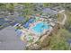 Overhead view of the community pool, lounge areas, spa, parking, and meticulously maintained landscaping at 4239 Fawn Meadows Cir, Clermont, FL 34711