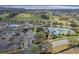 Community aerial showcasing the clubhouse, pool, tennis courts, and surrounding golf course at 4239 Fawn Meadows Cir, Clermont, FL 34711