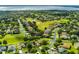 Aerial view showcasing the well-maintained homes, verdant landscaping, and serene water features at 4239 Fawn Meadows Cir, Clermont, FL 34711