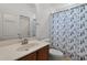 Bathroom featuring a modern vanity, decorative shower curtain, and tiled floors at 4239 Fawn Meadows Cir, Clermont, FL 34711