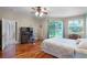 Bright bedroom features wood floors, ceiling fan, and a sliding glass door to outside at 4239 Fawn Meadows Cir, Clermont, FL 34711