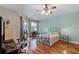 Bedroom with hardwood flooring, ceiling fan, and a decorative wrought iron bed at 4239 Fawn Meadows Cir, Clermont, FL 34711