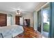 Open bedroom with hardwood floors, ceiling fan, and lots of natural light at 4239 Fawn Meadows Cir, Clermont, FL 34711