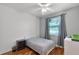 Bedroom with wood flooring, ceiling fan, and a window with grey curtains at 4239 Fawn Meadows Cir, Clermont, FL 34711
