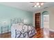 Bedroom with hardwood floors, a ceiling fan, a wrought iron bed, and built-in bookcase at 4239 Fawn Meadows Cir, Clermont, FL 34711