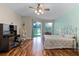 Bright bedroom features wood floors, a ceiling fan, and a sliding glass door to outside at 4239 Fawn Meadows Cir, Clermont, FL 34711