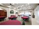 Clubhouse interior featuring billiards tables, seating, and televisions at 4239 Fawn Meadows Cir, Clermont, FL 34711