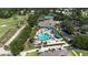 Aerial view of an exclusive community with golf course, tennis courts, playground, clubhouse and resort-style pool at 4239 Fawn Meadows Cir, Clermont, FL 34711