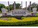 The Legends Golf & Country Club entrance sign surrounded by manicured greenery and flowers at 4239 Fawn Meadows Cir, Clermont, FL 34711
