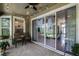 Relaxing covered patio with ceiling fan, string lights, and sliding glass doors to the home's interior at 4239 Fawn Meadows Cir, Clermont, FL 34711