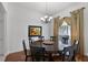 Dining room featuring a round table with seating for six, hardwood floors, and natural light at 4239 Fawn Meadows Cir, Clermont, FL 34711