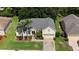 Attractive home with a well-maintained lawn, mature trees, and a paved driveway at 4239 Fawn Meadows Cir, Clermont, FL 34711