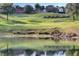 Scenic view of 'LEGENDS' etched into the hillside of the golf course next to a pond at 4239 Fawn Meadows Cir, Clermont, FL 34711