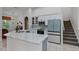 Modern kitchen with a large island, stainless steel appliances, and access to the staircase at 4239 Fawn Meadows Cir, Clermont, FL 34711