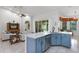 Stylish kitchen with blue cabinets, island sink, and open views to the living area at 4239 Fawn Meadows Cir, Clermont, FL 34711