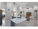 Open concept kitchen with island, granite countertops, and stainless steel appliances flows into the living room at 4239 Fawn Meadows Cir, Clermont, FL 34711