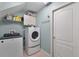 Modern laundry room features a washer, dryer, storage shelves, and ample space at 4239 Fawn Meadows Cir, Clermont, FL 34711