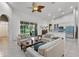 Bright living room features a screened lanai and an open-concept design with kitchen at 4239 Fawn Meadows Cir, Clermont, FL 34711