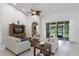 Comfortable living room boasts sliding doors to a screened-in patio with backyard views at 4239 Fawn Meadows Cir, Clermont, FL 34711